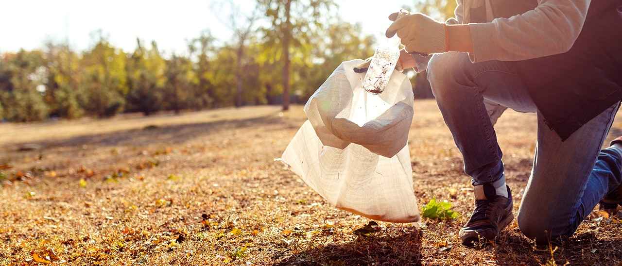 Foto de una persona recogiendo plásticos